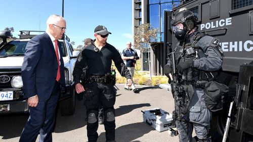 Australian Prime Minister Malcolm Turnbull speaks to members of a Tactical Response Team (TRT) during a tour of the AFP Forensics Facility at Majura in Canberra today. (AAP)