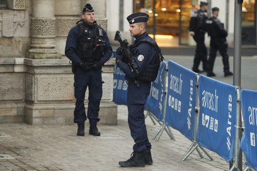 Police officers patrol during the funeral ceremony of French teacher Dominique Bernard, 57, who was stabbed to death at the school by a suspected Islamist extremist, in Arras, northern France, Thursday, Oct. 19, 2023. 