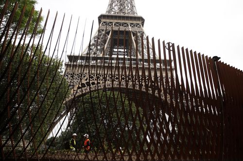 An unsightly metal fence was originally built around the Eiffel Tower. Image: AAP 