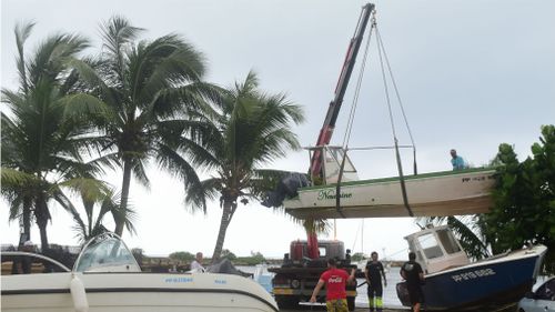 Men remove boats from the water ahead of Hurricane Maria in the Galbas area of Sainte-Anne on the French Caribbean island of Guadeloupe. (AAP)