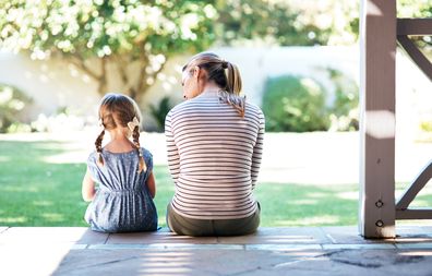 Mother and her daughter having a conversation on the porch