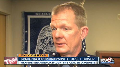 US police officer prays with driver distraught over daughter’s cancer diagnosis