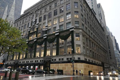 Saks Fifth Avenue's flagship Fifth Avenue store is partially boarded up, Sunday, Nov. 1, 2020, in New York. Retailers including Nordstrom, Tiffany, and Saks are planning to board up their windows or add extra security personnel in some of their locations ahead of the contentious presidential election on Tuesday. 