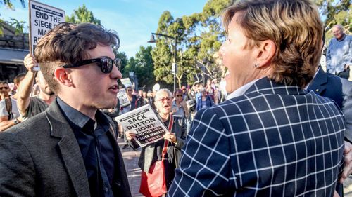 A protester confronts Christine Forster at an event for her brother, former prime minister Tony Abbott. (AAP)