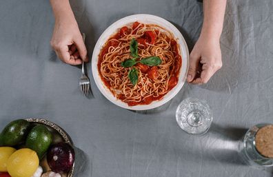 A plate of pasta with tomato sauce