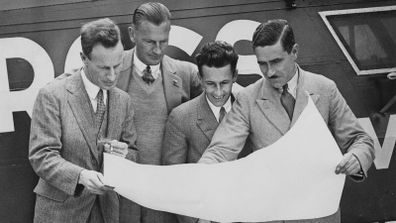 The four-man crew of the Southern Cross monoplane study a map of their route at Croydon airport in June 1930, and from Left to right,  Australian aviator Charles Kingsford Smith, co-pilot Evert Van Dyke, radio operator John Stannage and navigator J. Patrick Saul.