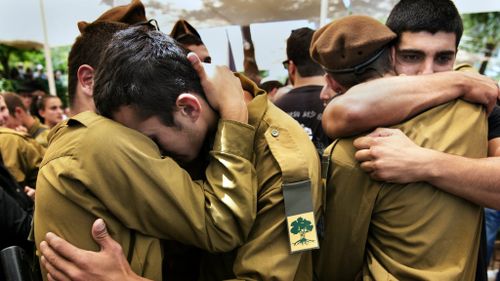 Israeli soldiers grieve for a comrade killed during the latest round of Gaza violence. (Getty)