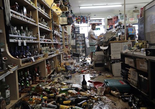 Bottles of alcohol and other products are strewn on the floor behind the main counter of the Eastridge Market on July 6, 2019, in Ridgecrest, California. Crews in Southern California assessed damage to cracked and burned buildings, broken roads, leaking water and gas lines and other infrastructure after the largest earthquake the region has seen in nearly 20 years jolted an area from Sacramento to Las Vegas to Mexico. 