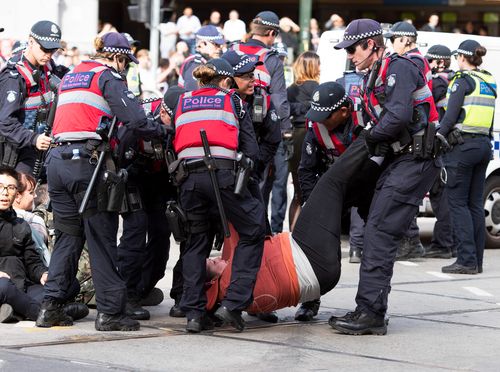 Some protesters needed to be carried by police. (AAP Image/Ellen Smith) 