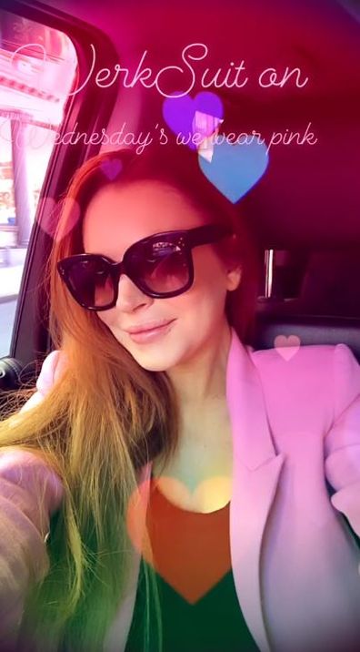 Lindsay Lohan, dancing, outside gas station, pink suit