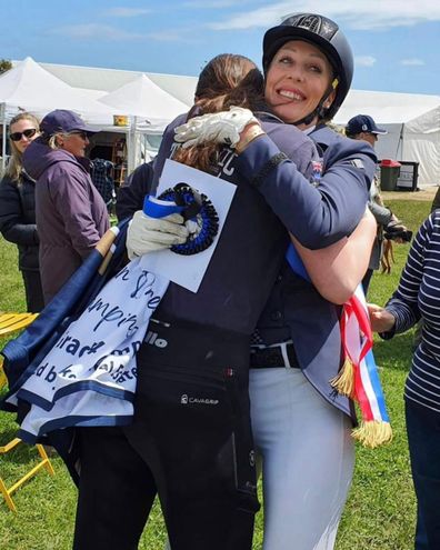 Kylie Christian hugs her daughter Honour after an equestrian event.