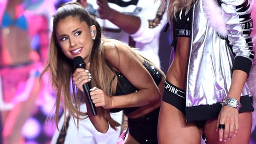 Ariana Grande cowers after Victoria's Secret model's angel wing hits her in the face 