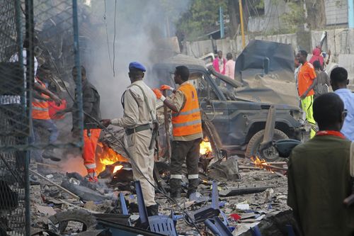 A Somali soldier inspects wreckage of vehicles after a car bomb that was detonated in Mogadishu. (AP)