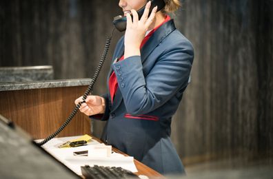 Female front of desk hotel worker.