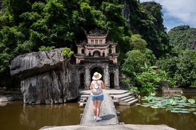 Selective focus. Tourist walking around Bich Dong Pagoda, Ninh Binh, Vietnam. Incredible Vietnamese pagoda. Beautiful Vietnamese temple inside a cave. Beautiful Bich Dong Pagoda