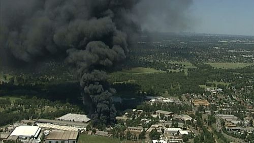 Plumes of black smoke fill the sky above the factory. (9NEWS Choppercam)