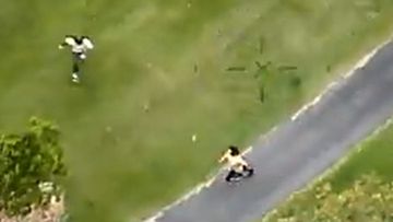 Dramatic footage of two men leading police on a wild chase across the Gold Coast, before being tackled to the ground by a brave local.