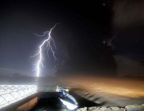 As tremors shook the area, volcanic lightning flickered in the column of steam and ash.