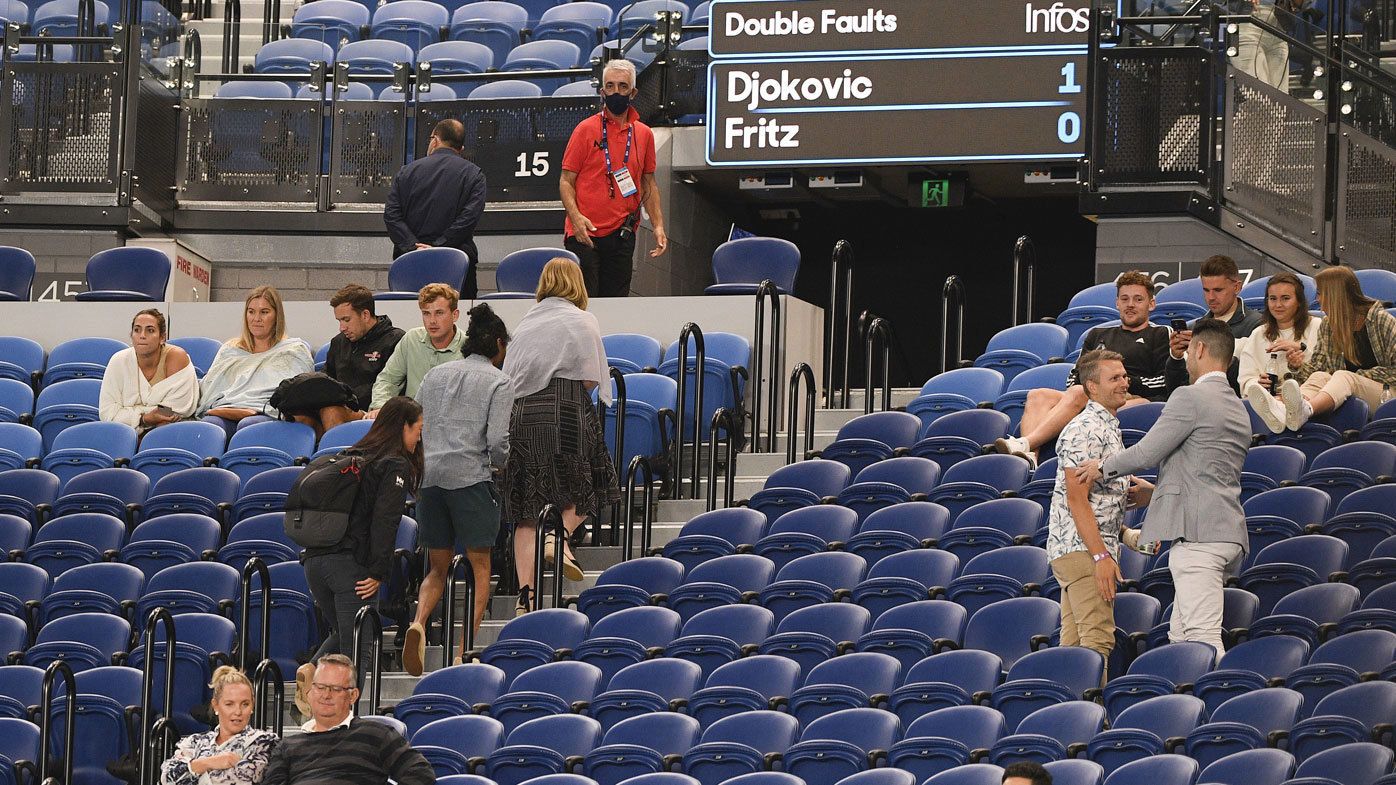 Spectators are asked to leave Rod Laver Arena during the third round match between Serbia&#x27;s Novak Djokovic and United States&#x27; Talyor Fritz at the Australian Open tennis championship in Melbourne, Australia, Friday, Feb. 12, 2021