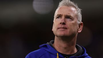 PERTH, AUSTRALIA - AUGUST 12: Adam Simpson, head coach of the Eagles looks to the scoreboard while walking to the rooms at the half time break during the round 22 AFL match between West Coast Eagles and Fremantle Dockers at Optus Stadium, on August 12, 2023, in Perth, Australia. (Photo by Paul Kane/Getty Images)