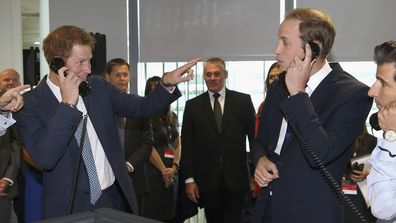 Prince William, Duke of Cambridge, right, and his brother Prince Harry take part in a trade on the trading floor of BGC Partners, during BGC Charity Day 2013, in Canary Wharf, London, Wednesday, September 11, 2013.