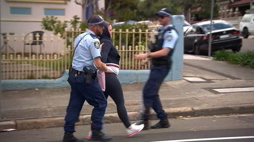 A woman was taken into custody after allegedly assaulting a 9News journalist after a police pursuit in Sydney.