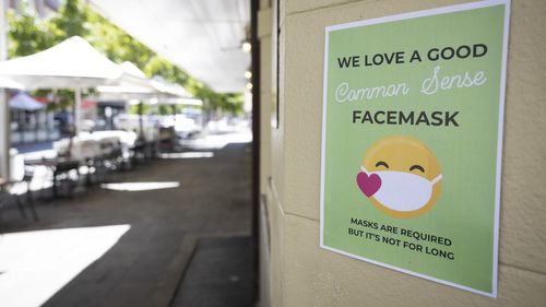 PERTH, AUSTRALIA - DECEMBER 24: A sign on display advises the public to the requirements of face masks on December 24, 2021 in Perth, Australia. The Western Australian government has implemented new COVID-19 restrictions, following the detection of a new community COVID-19 case. From 6pm on Thursday, masks will be mandatory in all public indoor settings in the Perth and Peel regions until December 28th. Authorities are also recommending people wear masks outdoors when physical distance can't be 