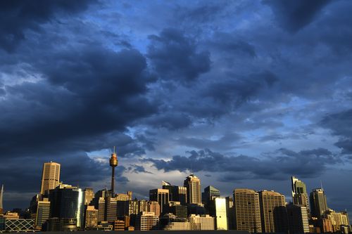 Clouds gather over the Sydney CBD skyline. Workers are expected to return to the office in greater numbers over the coming weeks.