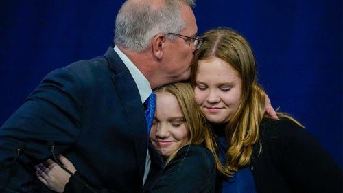 Outgoing Prime Minister Scott Morrison hugs his daughters Lily and Abbey.