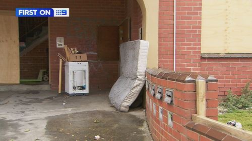 A﻿ man has been saved by his neighbours after they saw him hanging from the window of his burning apartment in Melbourne.