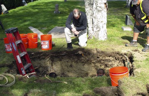 Workers and medical examiner crew members exhume the body of Jane Doe #3 from a cemetery in Anchorage, Alaska. (AP Photo/Rachel D'Oro, File)