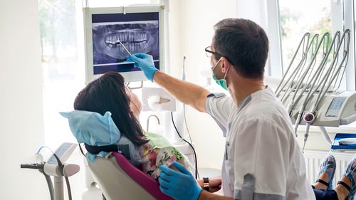 A dentist treats a patient.