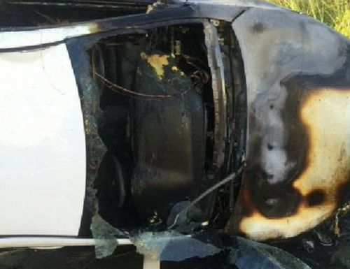 Not long after the officers pulled him out, flames filled the car. Picture: Supplied