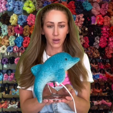 TikTok creator Erin Miller holding a '90s dolphin lamp