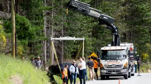 The McLaren F1 racer had to be lifted out of the ditch. (9NEWS)