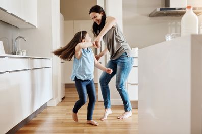 Girl dancing with her mother