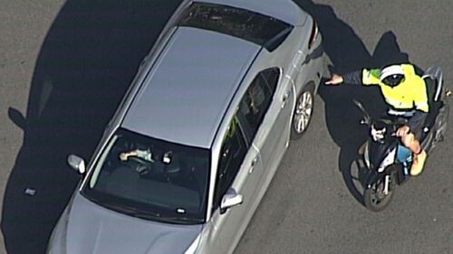 A man on a scooter pointed into Guider's car.