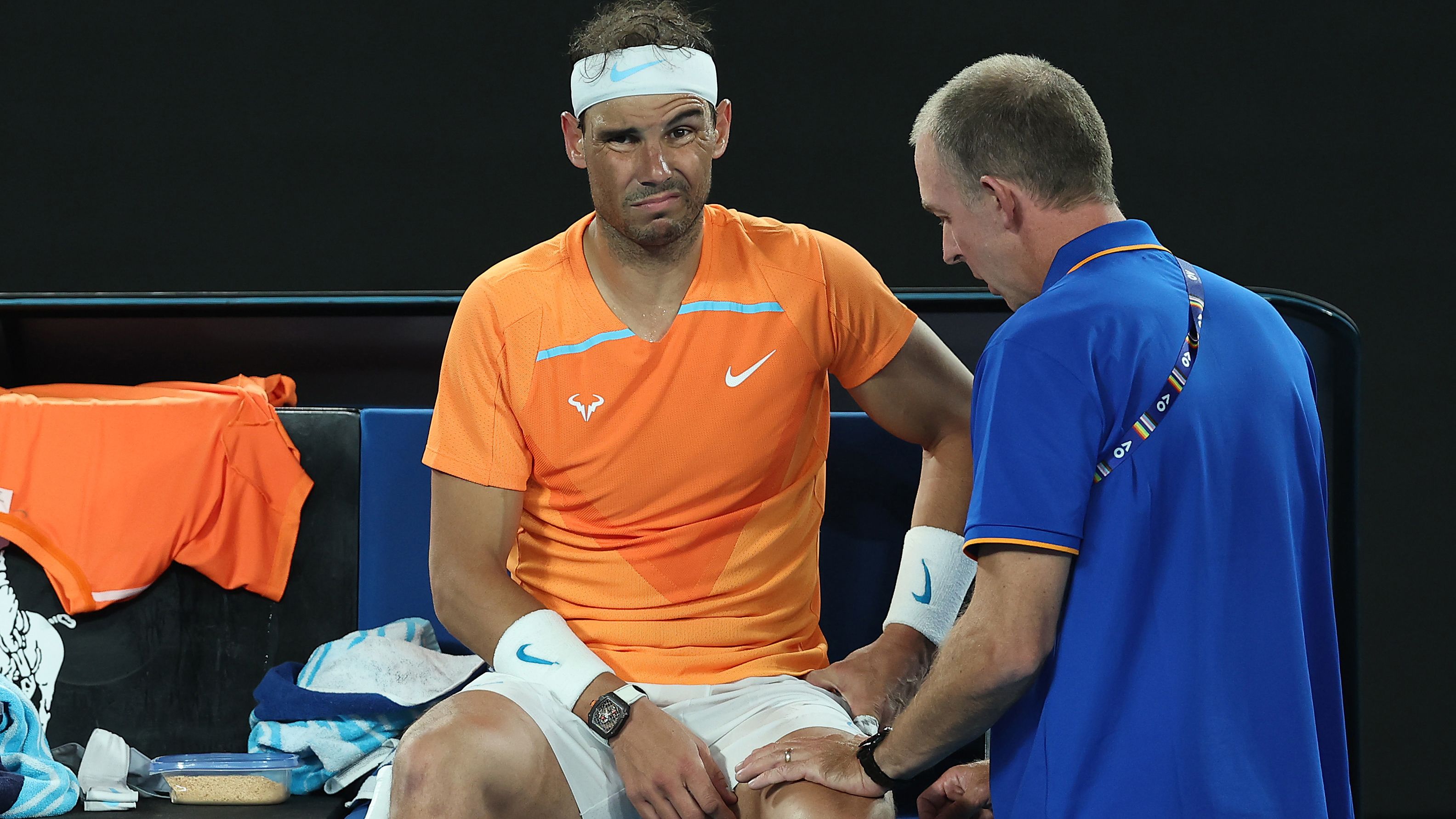 MELBOURNE, AUSTRALIA - JANUARY 18: Rafael Nadal of Spain receives attention during a medical time out in their round two singles match against Mackenzie McDonald of the United States during day three of the 2023 Australian Open at Melbourne Park on January 18, 2023 in Melbourne, Australia. (Photo by Cameron Spencer/Getty Images)