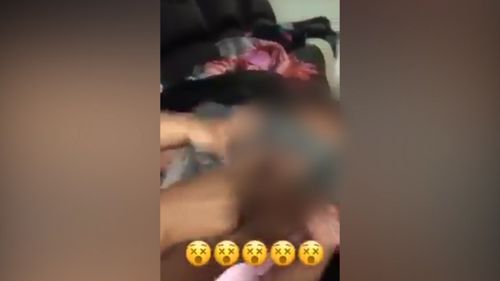 In another video, a toddler can be seen struggling to remove a bag from its face. (Snapchat)