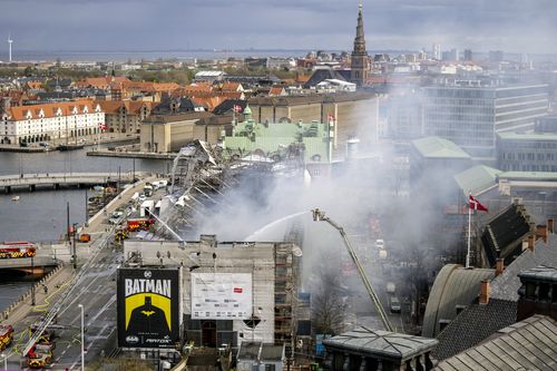 Firefighters work on the building after a fire broke out at the Stock Exchange in Copenhagen, Tuesday, April 16, 2024.  