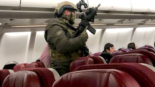 Police made more than 200 passengers stay on the plane for almost 90 minutes before storming the aircraft and arresting Marks.