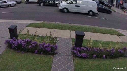 Security vision shows the family car pulling up as the girl waits on the side of the road. (Supplied)