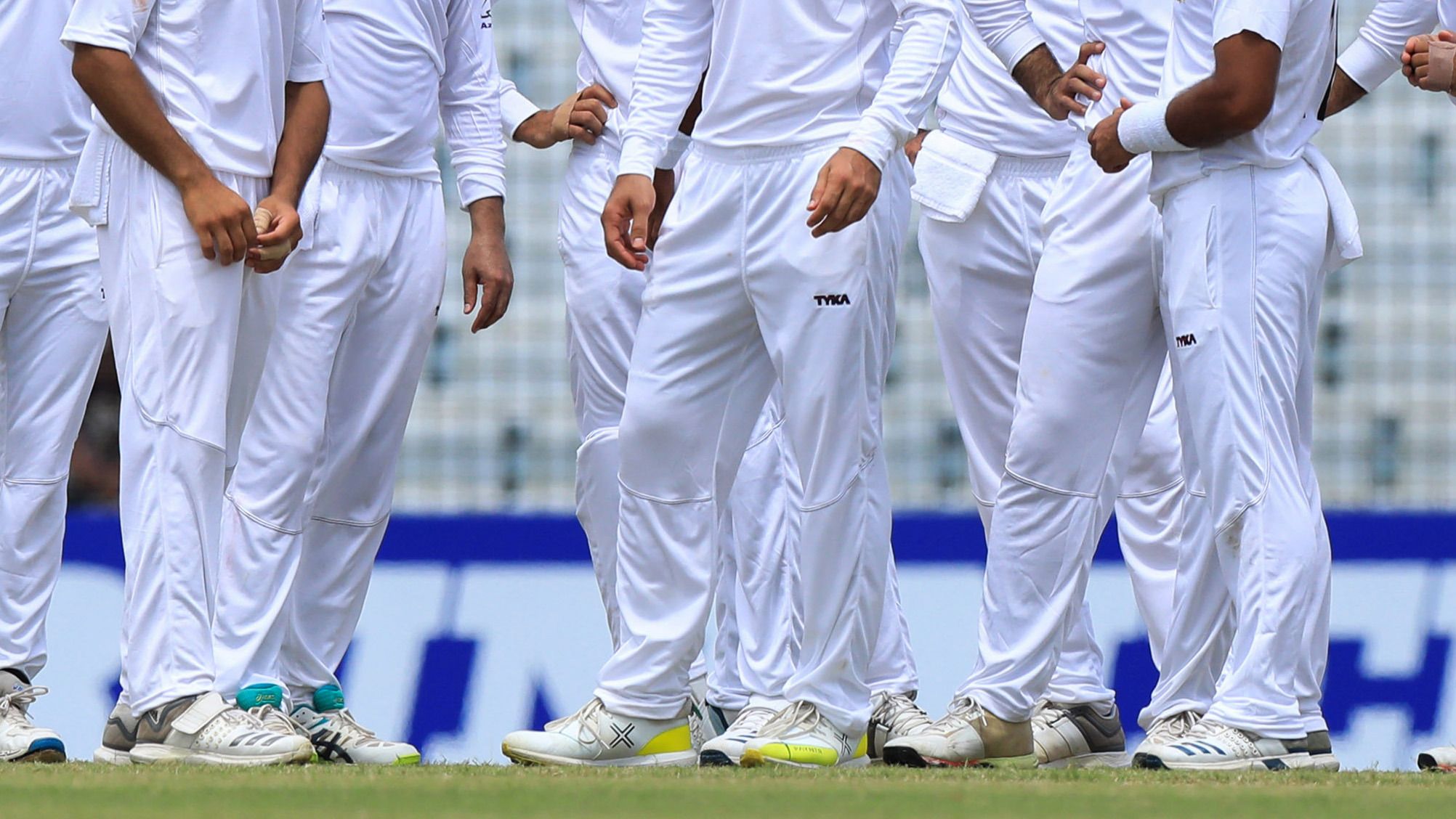 Cricket players in Test whites.