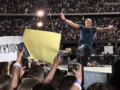Chris Martin falls through a hole on the stage during Coldplay concert