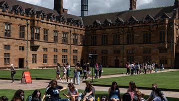 Students are seen walking through the Sydney University&#x27;s campus. 
