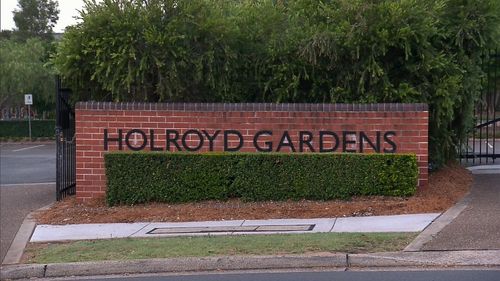 The man pushed the woman from behind as she neared the entrance to Holroyd Gardens.