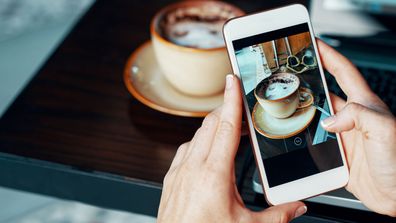 International data roaming woman taking photo of coffee