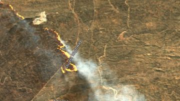 A fire burning across the Stuart Highway, north of Alice Springs.