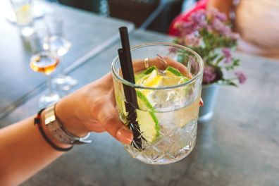 Close up of female hand holding Gin Tonic