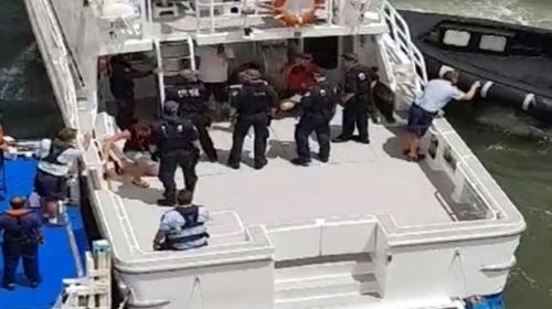 Six men and a woman were removed from the ship and onto an awaiting boat at Bradleys Head in Sydney. (9NEWS).